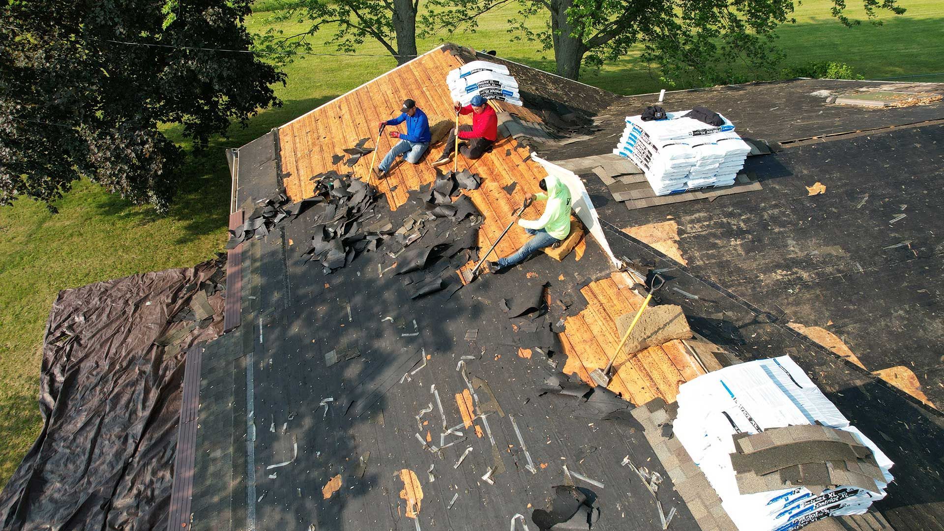 a group of people are replacing a roof