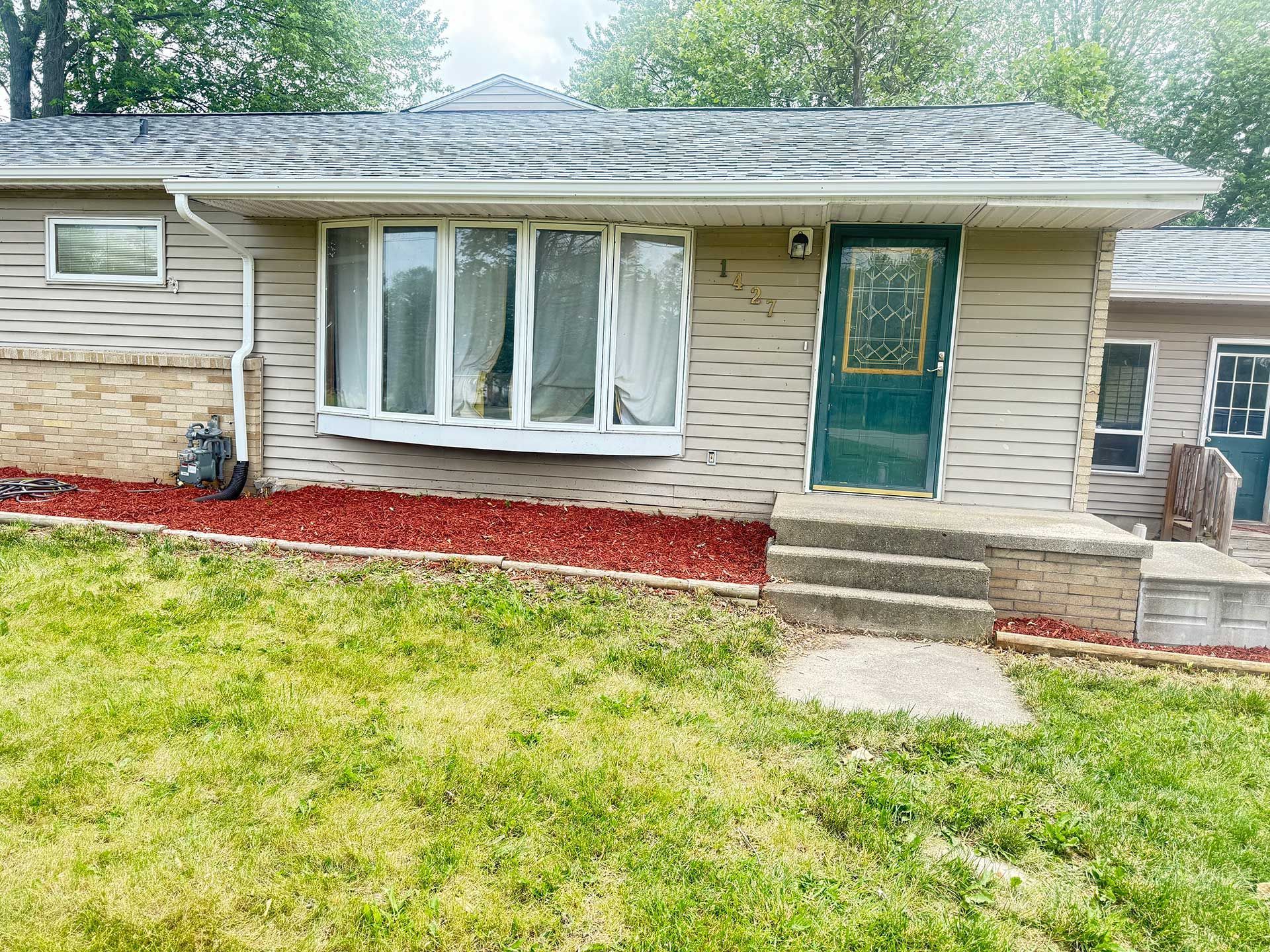 a small house with a large window and a door