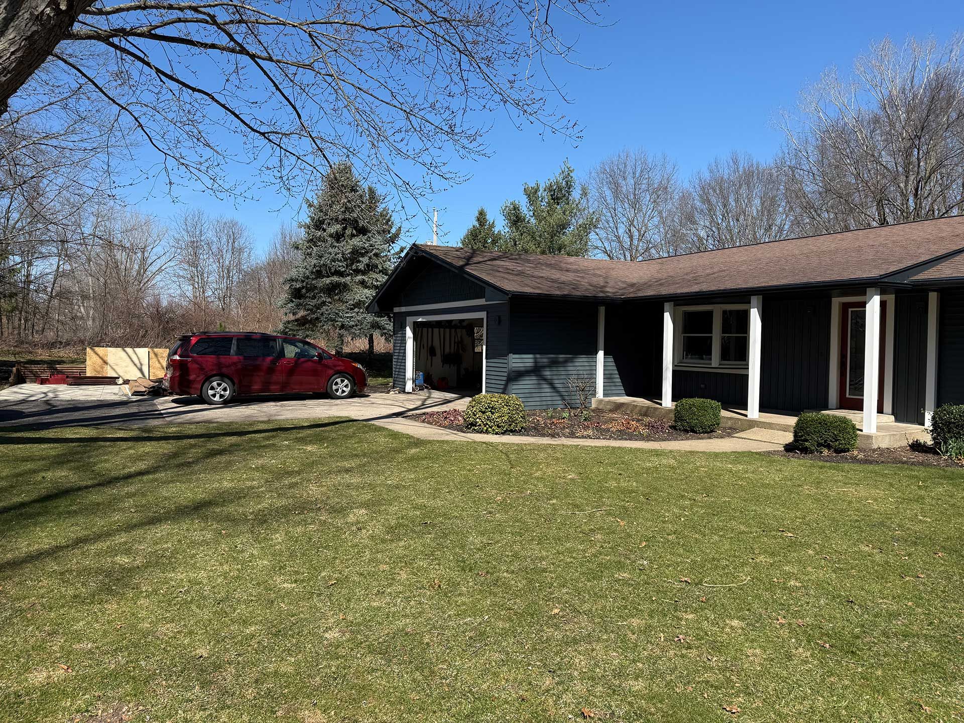 a red car is parked in front of a house