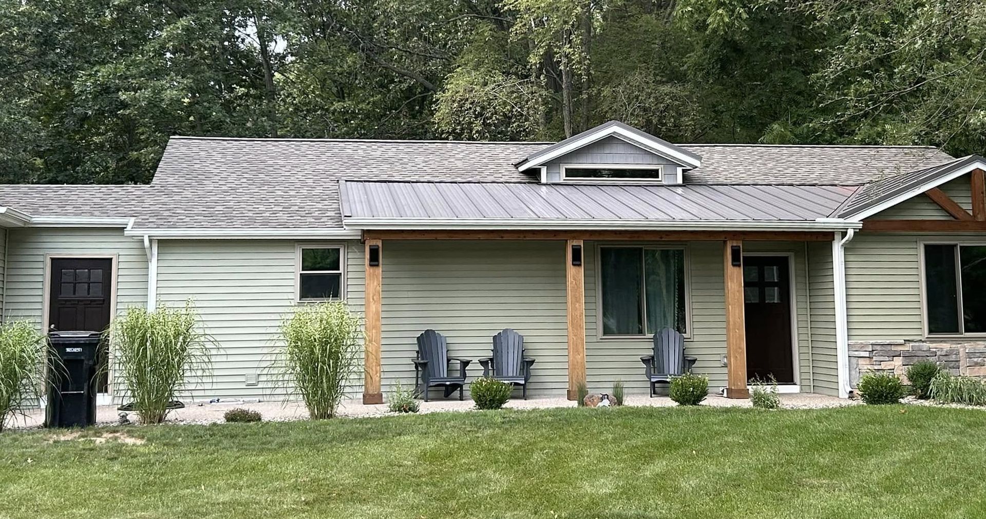 A house with a porch and chairs in front of it