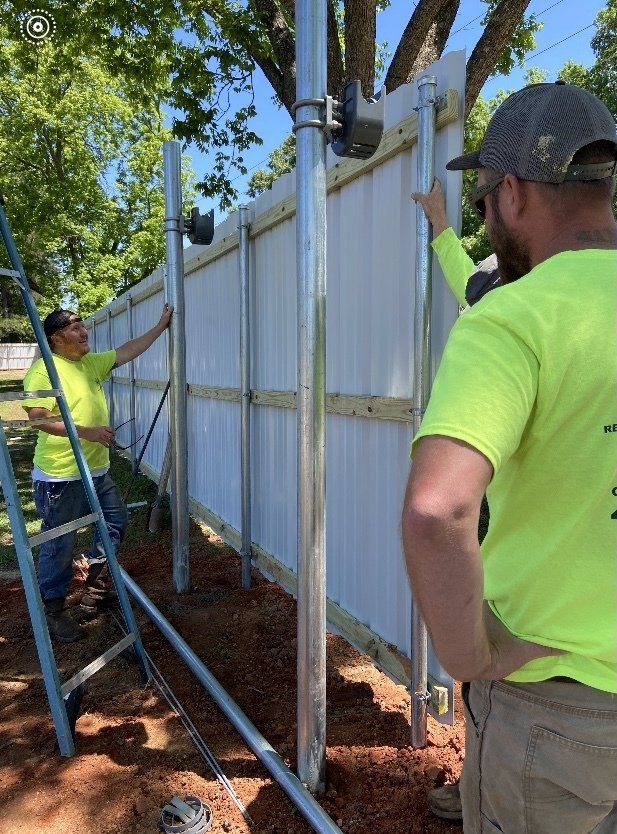 A group of men are working on a fence.