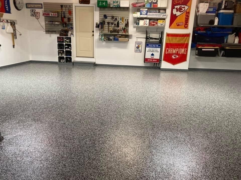 Garage with speckled epoxy floor, tools, and shelves.