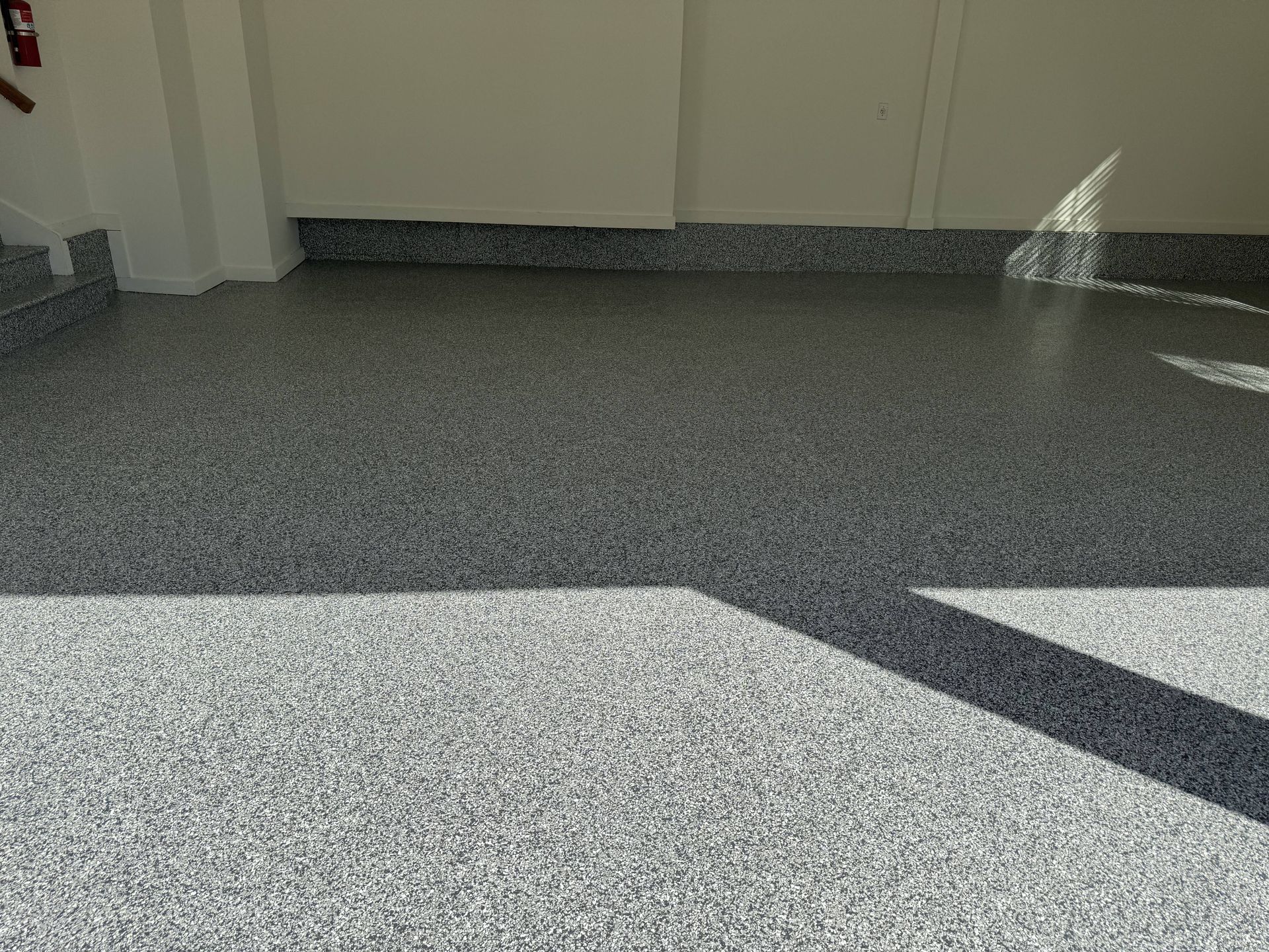 Gray speckled epoxy garage floor.