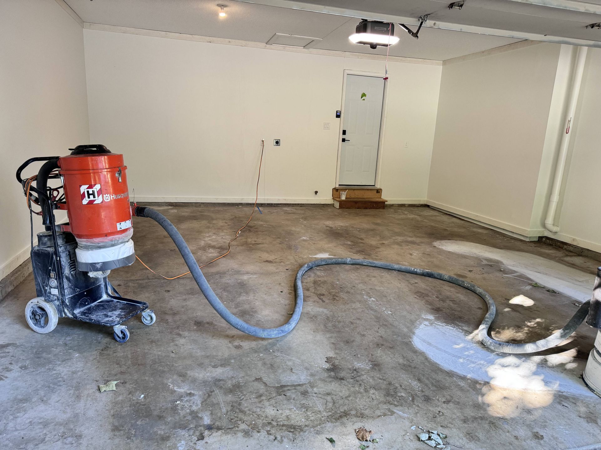 Floor grinding machine in garage, grinding concrete floor.