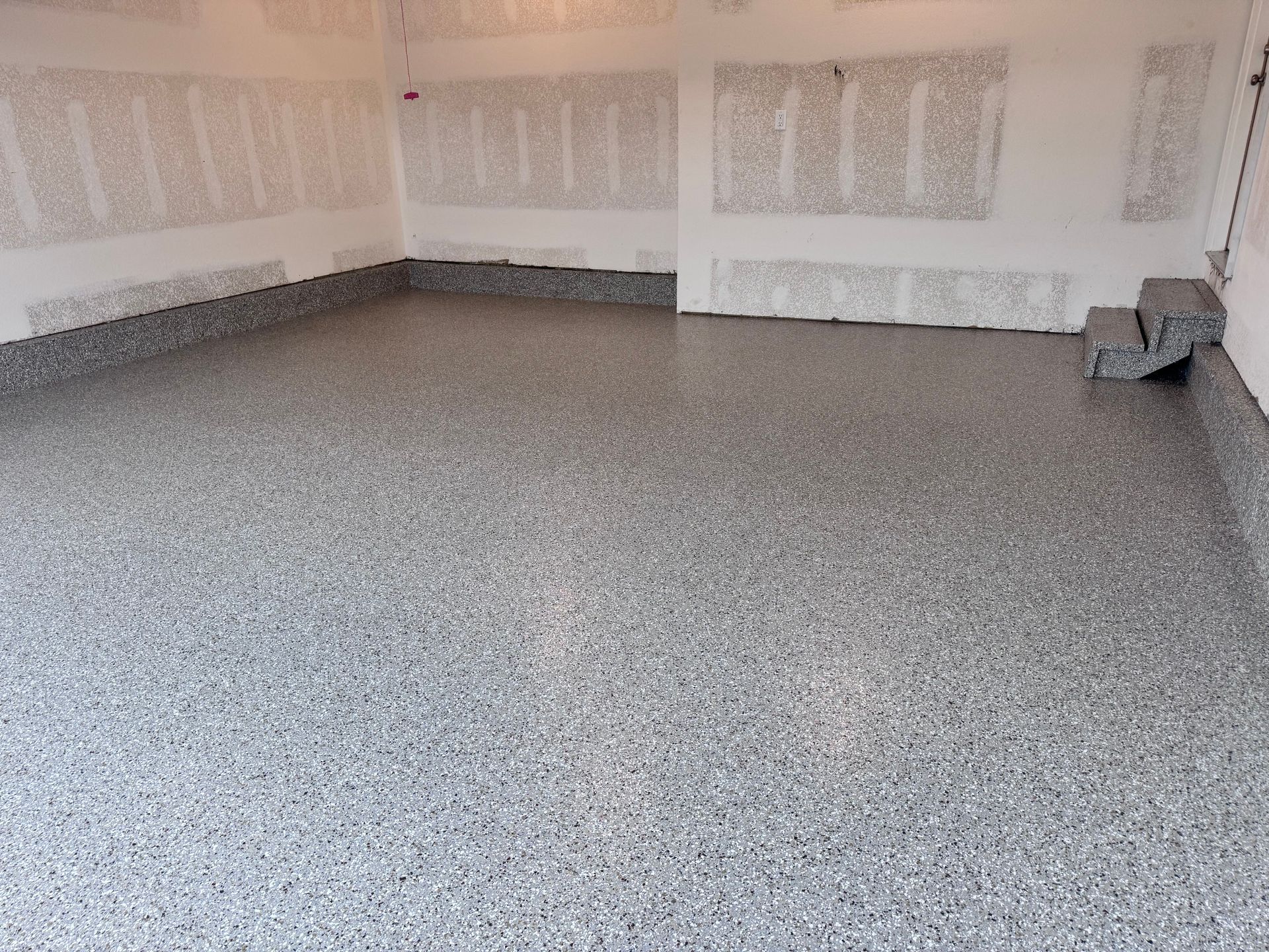 Gray speckled epoxy garage floor.