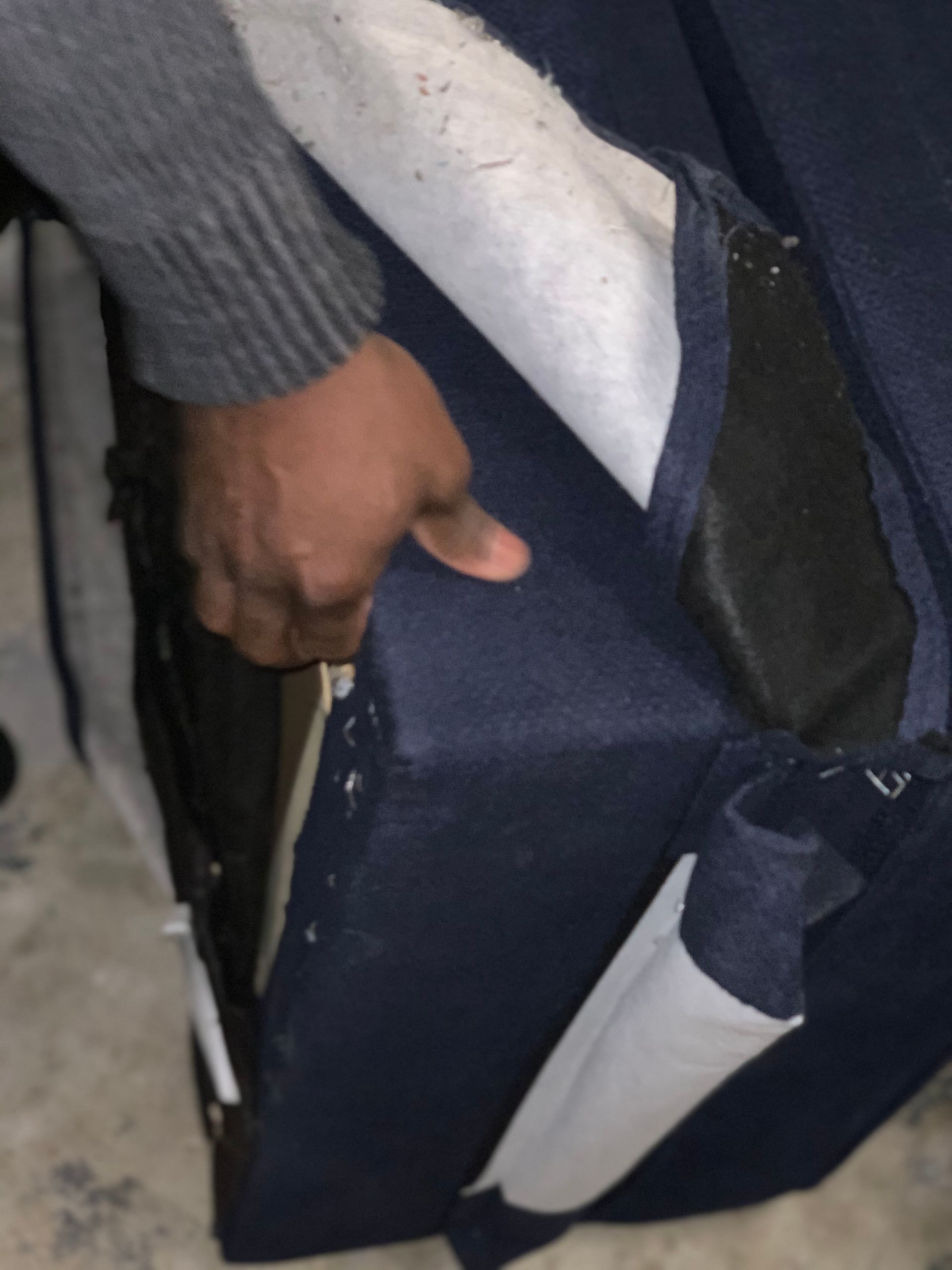 A person is holding a piece of blue fabric