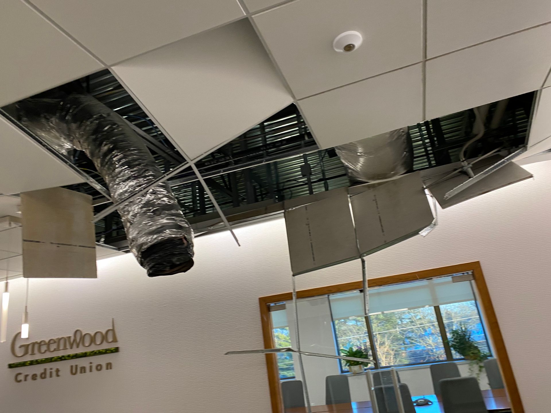 A greenwood credit union building with a hole in the ceiling