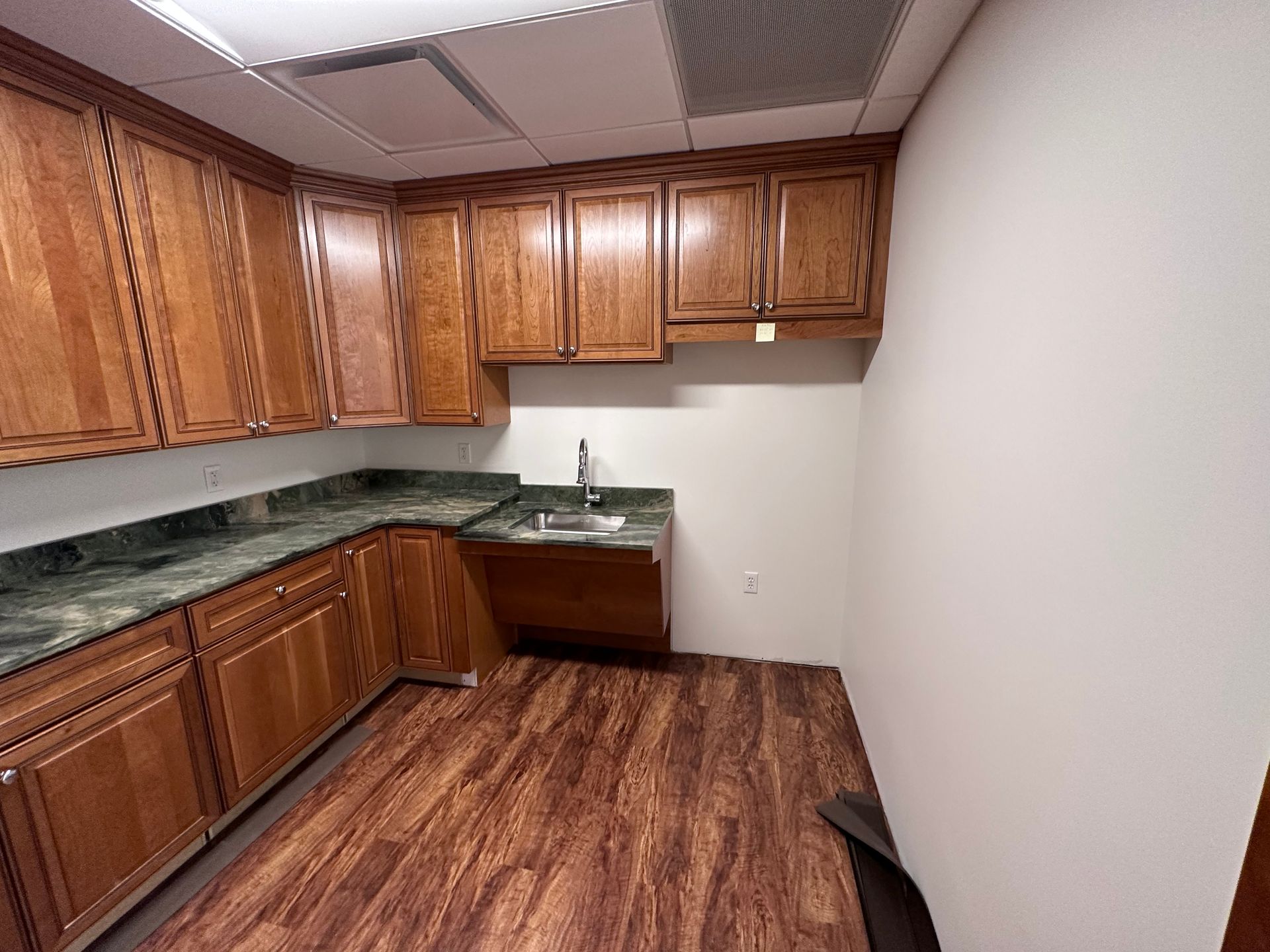 A kitchen with wooden cabinets and a sink