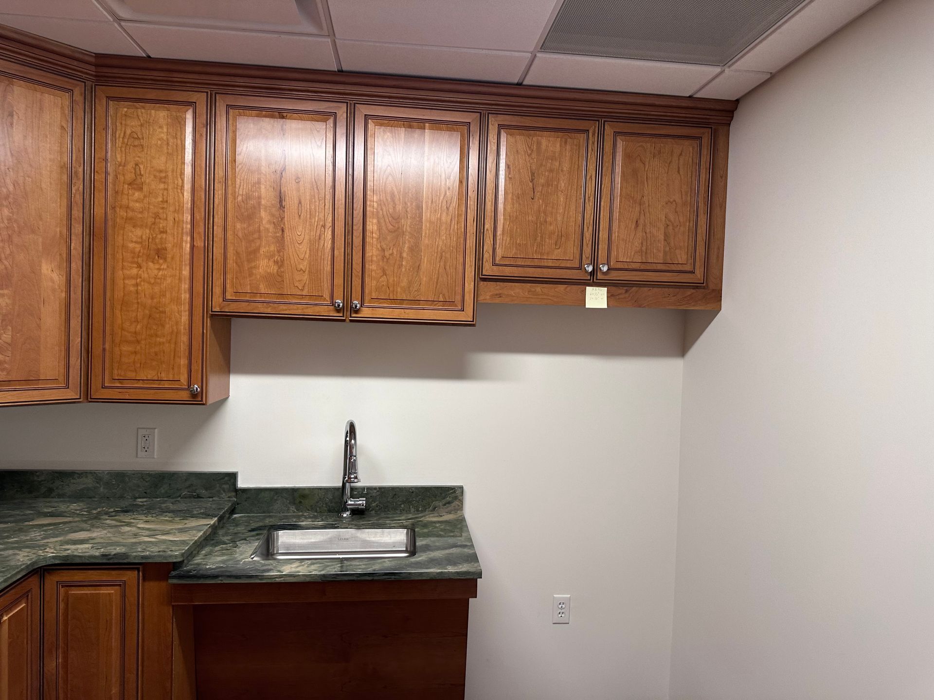 A kitchen with wooden cabinets and a sink