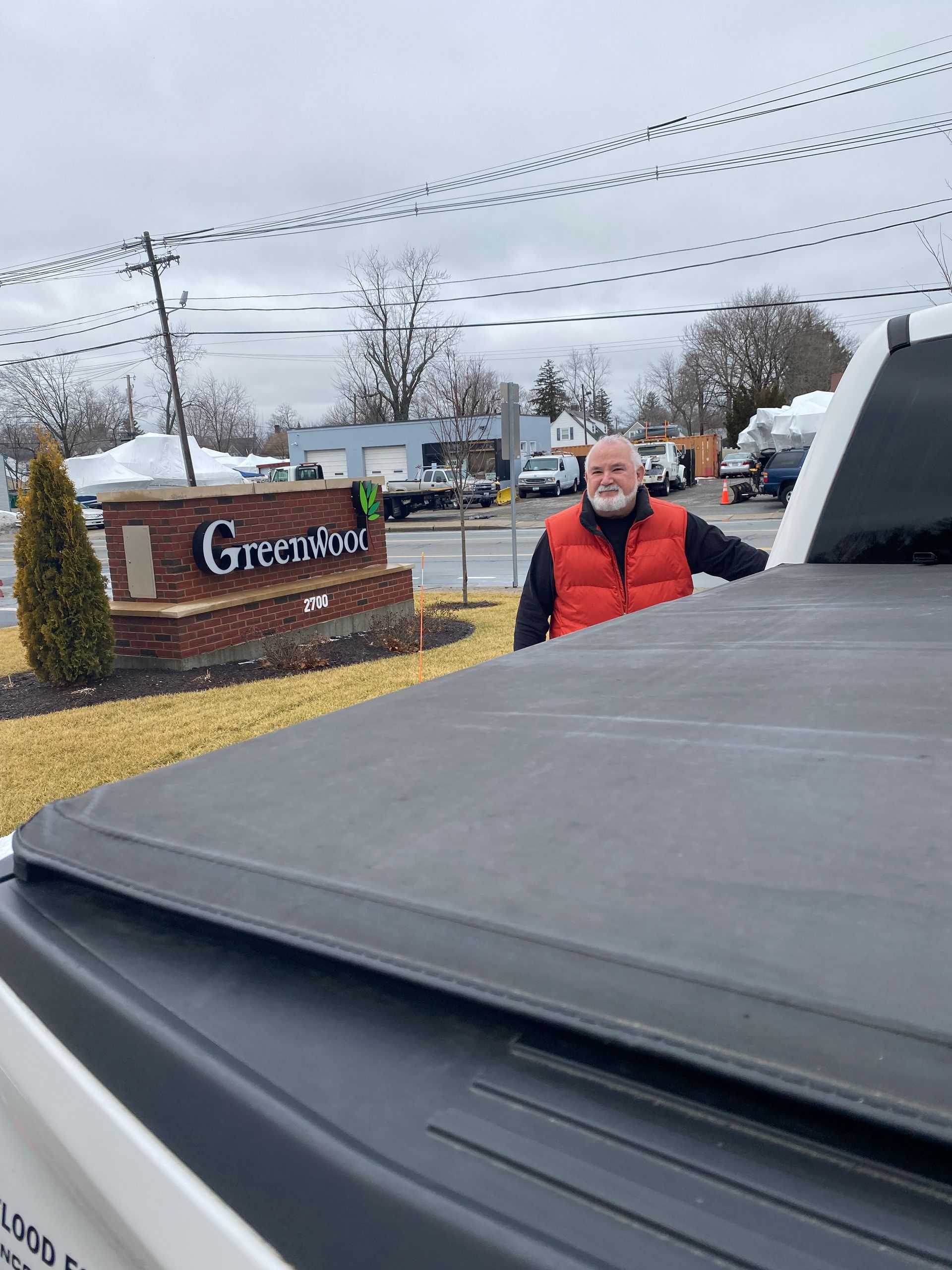 A man is standing in front of a sign that says greenview.
