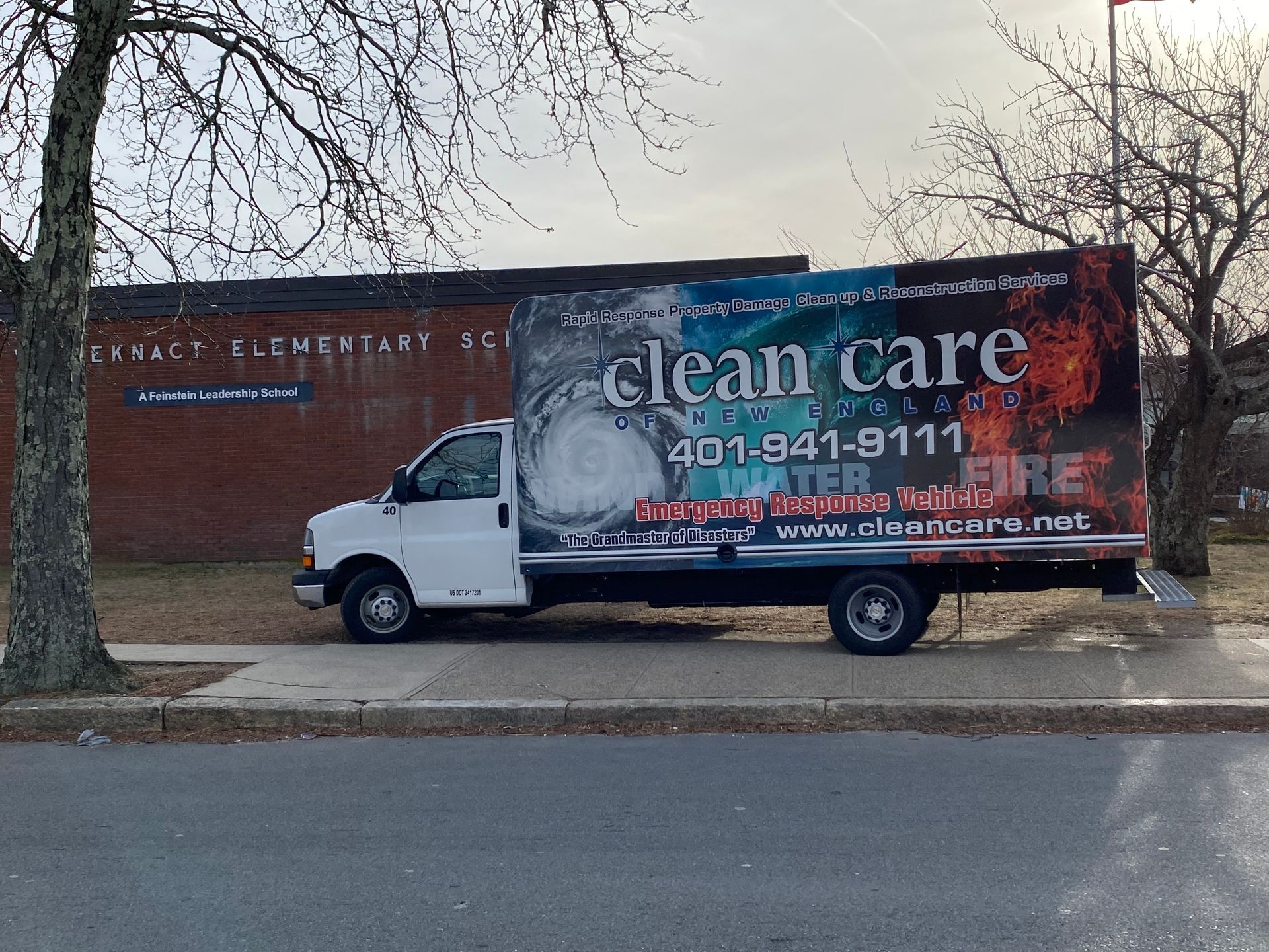 A clean care truck is parked on the side of the road