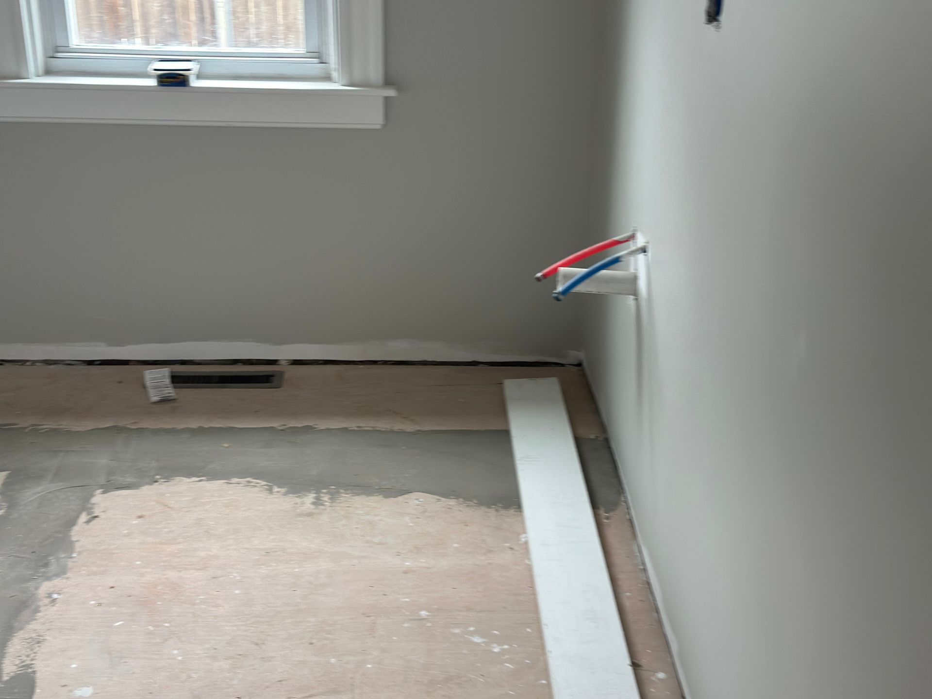 A room that is being remodeled with a window