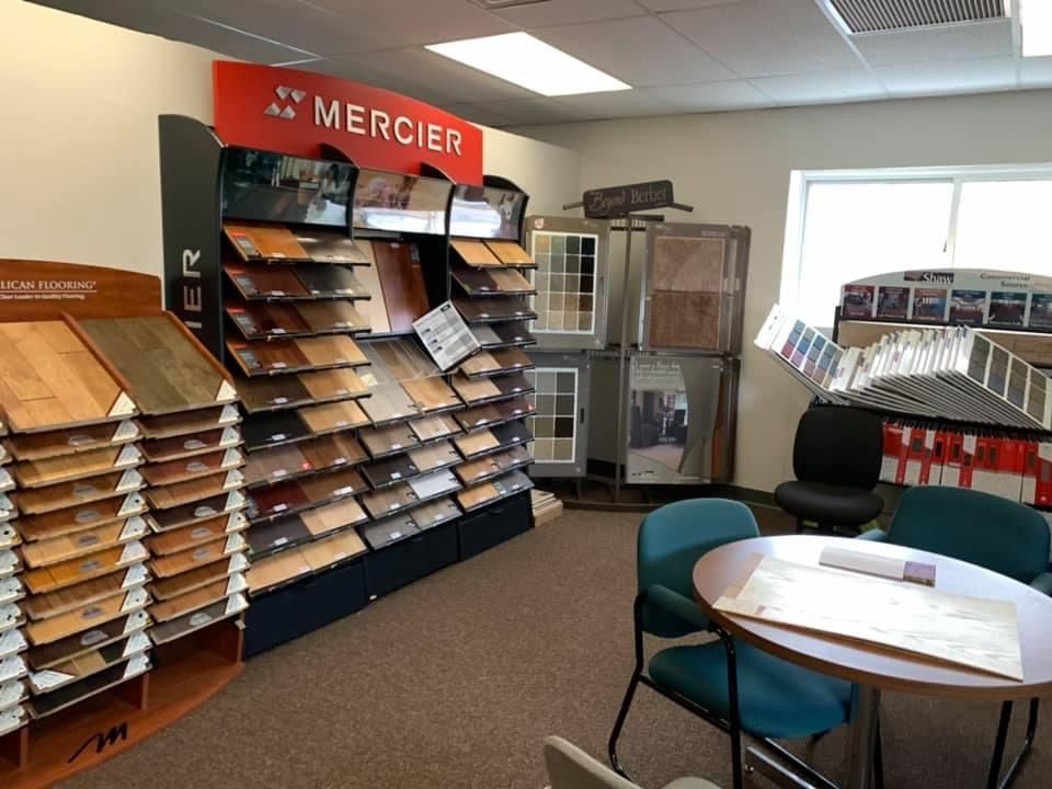 A room with a table and chairs and a sign that says mercier