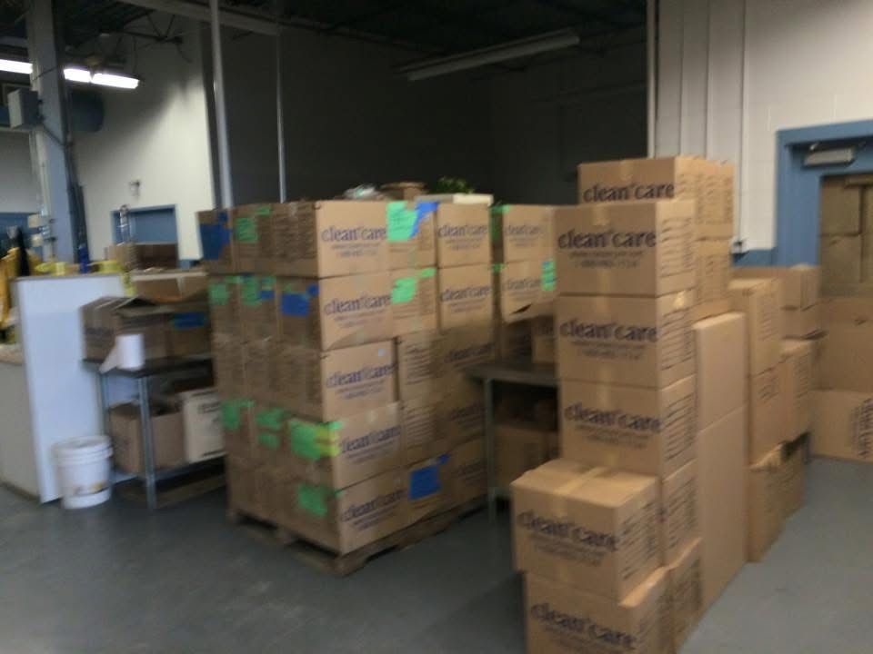 A warehouse filled with lots of cardboard boxes with clear care written on them