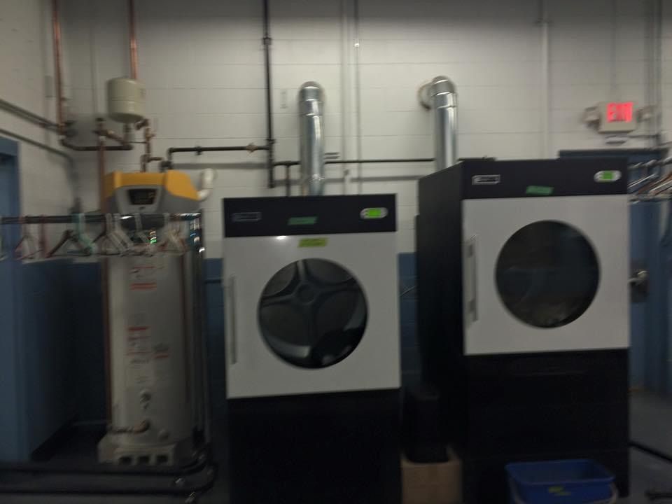 A laundromat with two washers and two dryers