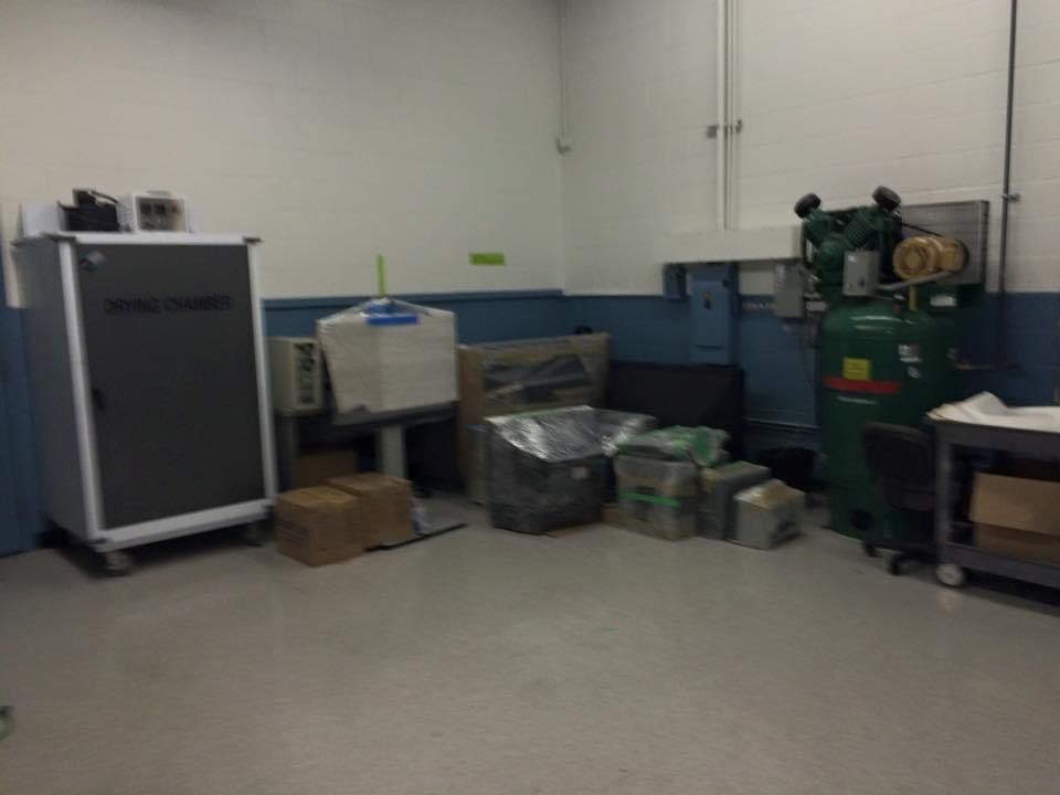 A room with a lot of boxes and a machine in it