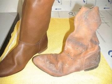 A pair of brown boots are sitting next to each other on a table.