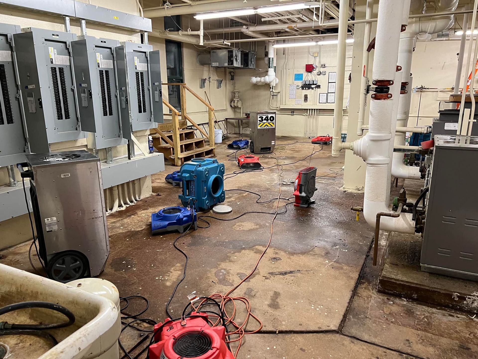 A dirty room with a lot of electrical equipment in it.