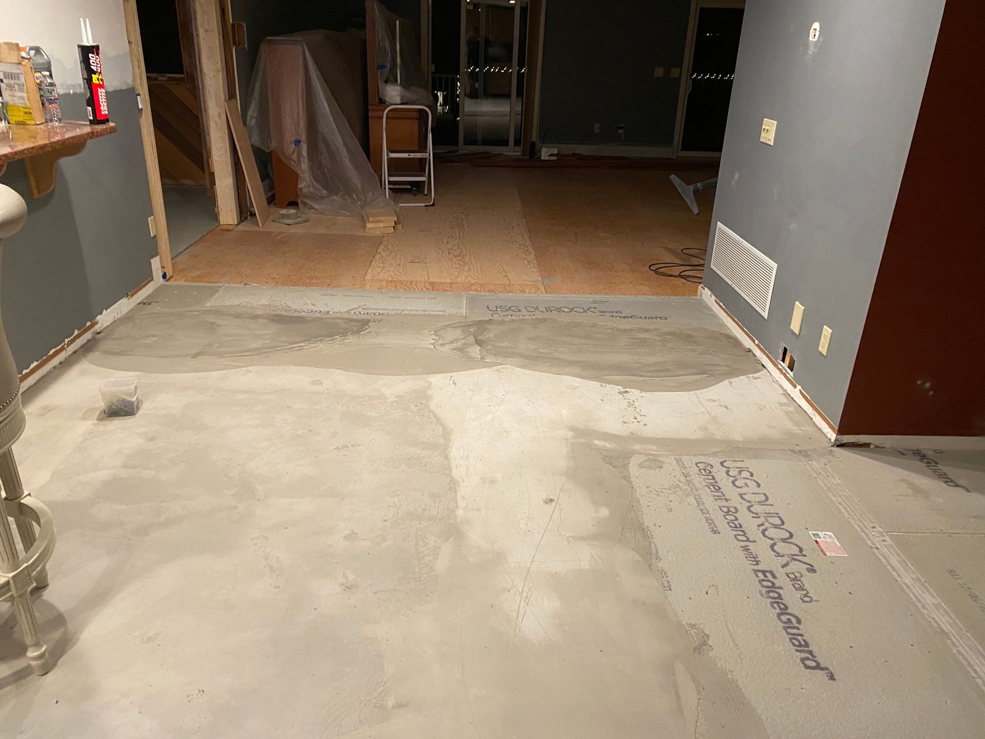 A room with a concrete floor and a sign on the floor that says ' concrete floor '