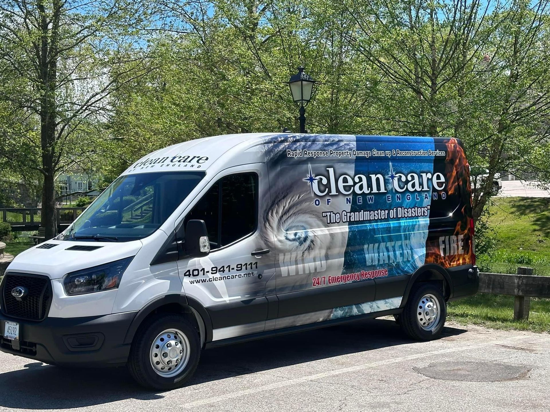 A clean care van is parked on the side of the road.
