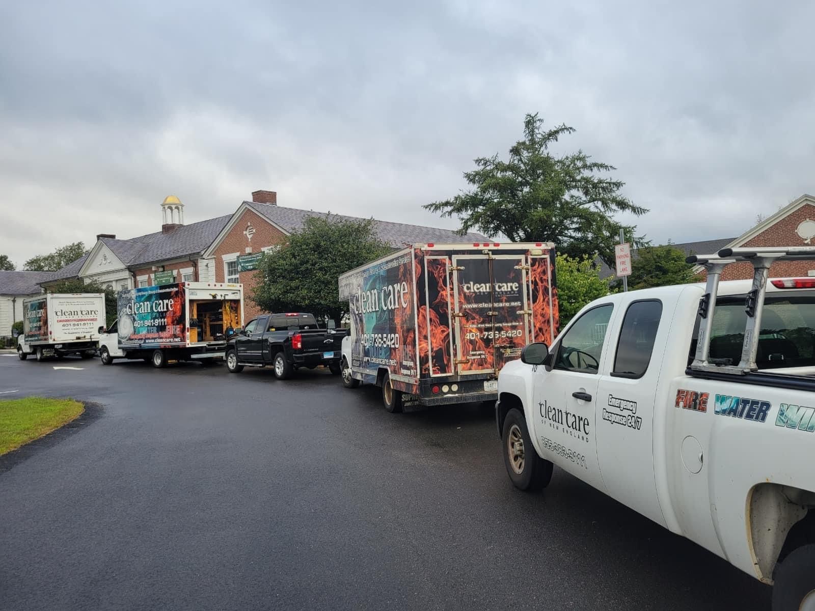 A row of food trucks are parked in a parking lot.