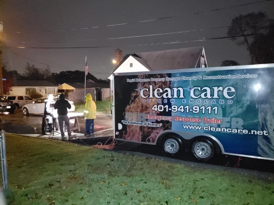 A clean care trailer is parked on the side of the road at night.