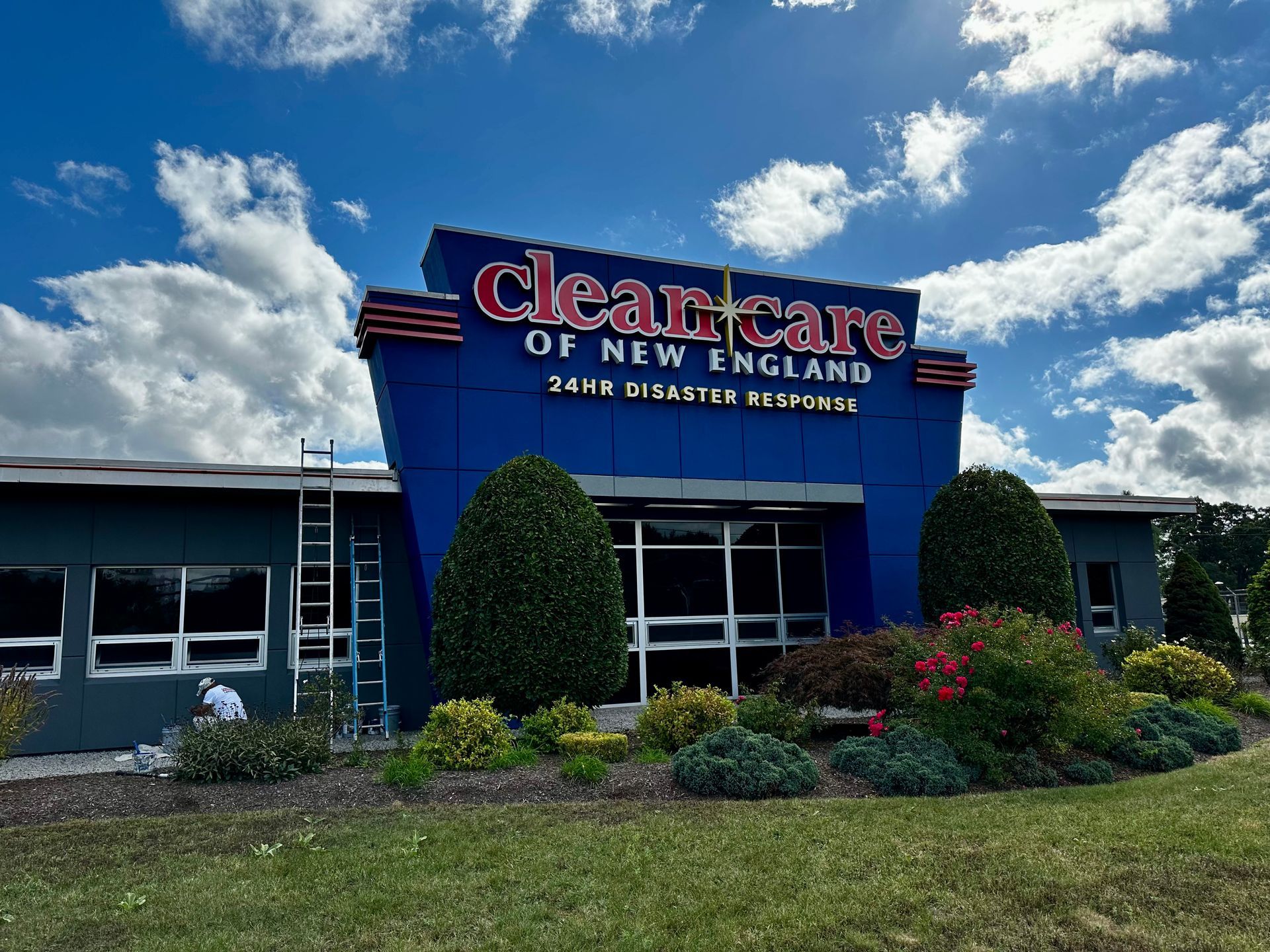 A blue building with a sign that says clean care of new england