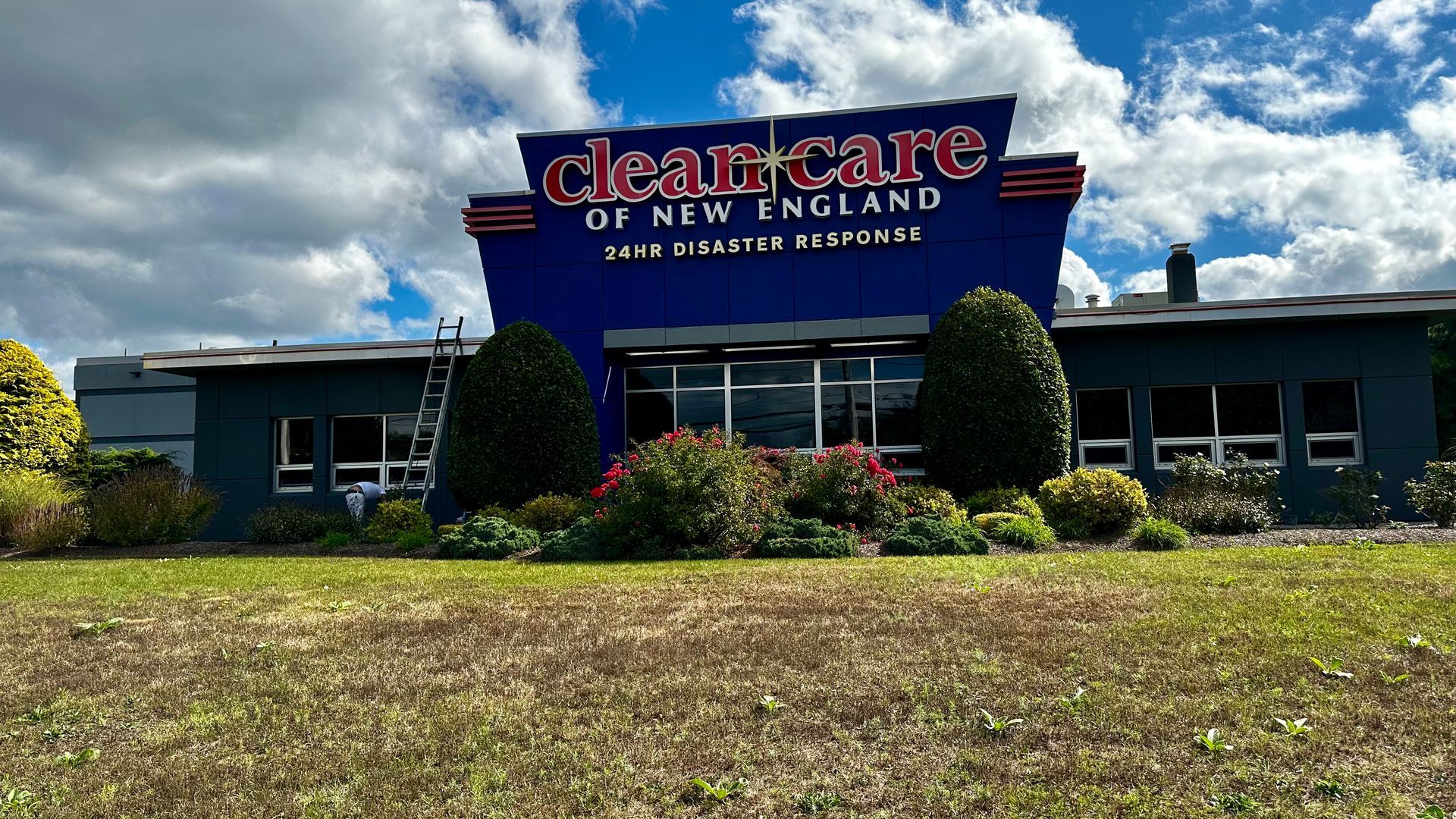 A blue building with a sign that says clean care of new england