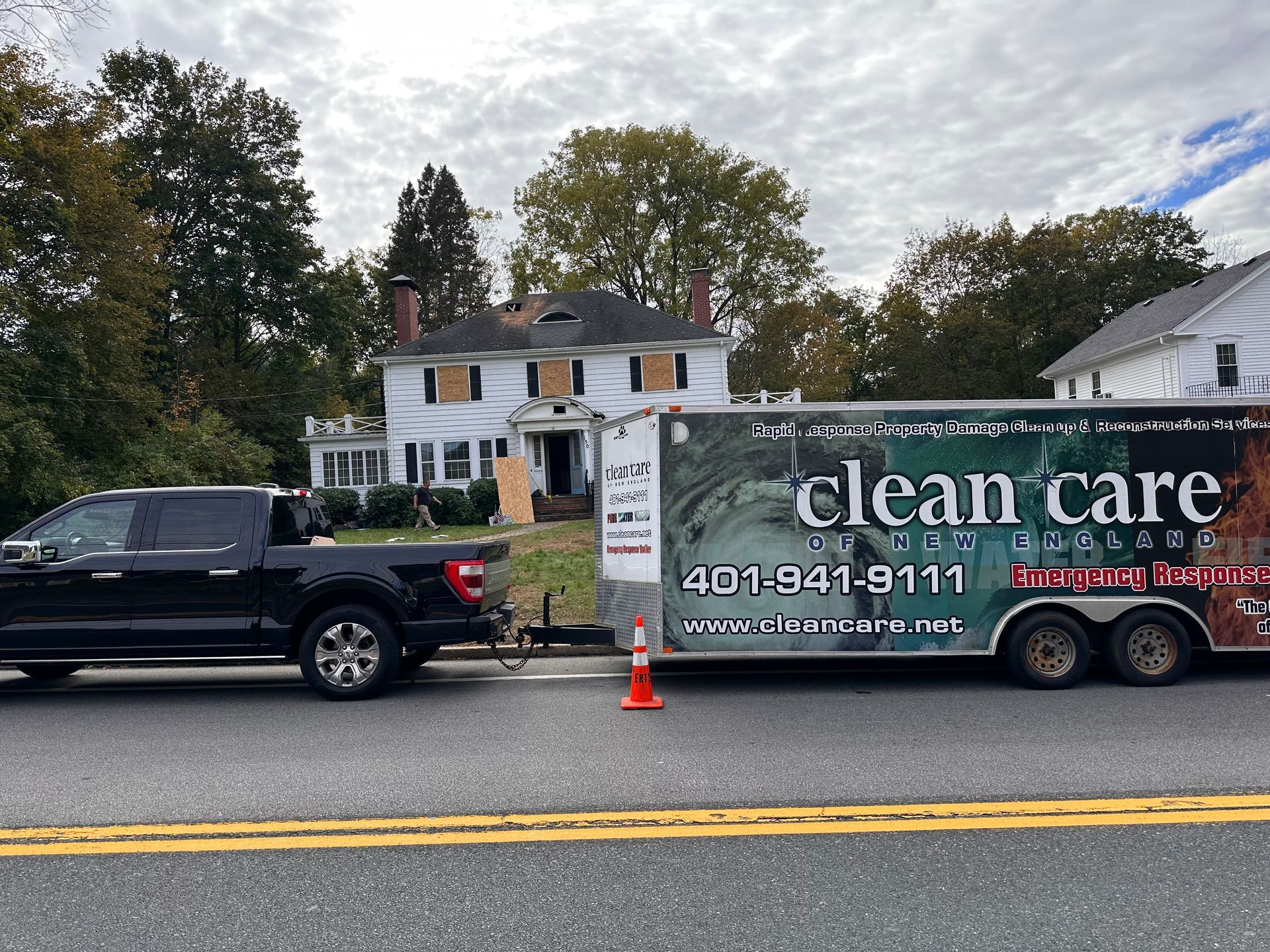 A truck is pulling a trailer that says clean care on it.