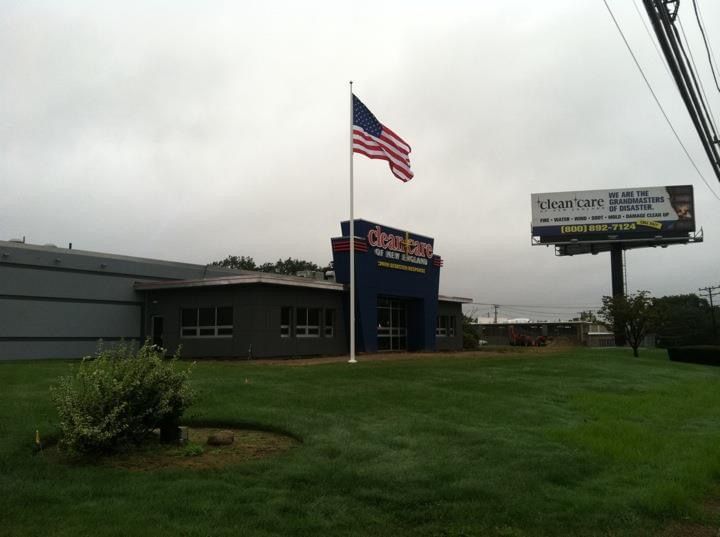 An american flag is flying in front of a building that says century 21