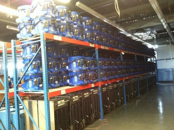 A warehouse filled with lots of blue buckets