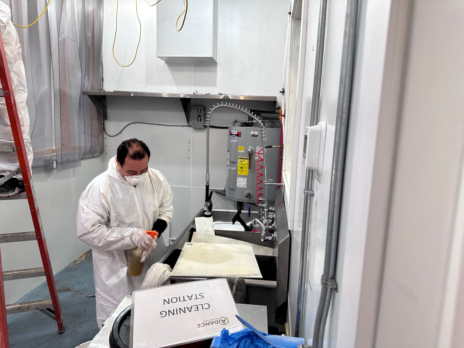 A man wearing a mask is working in a kitchen.