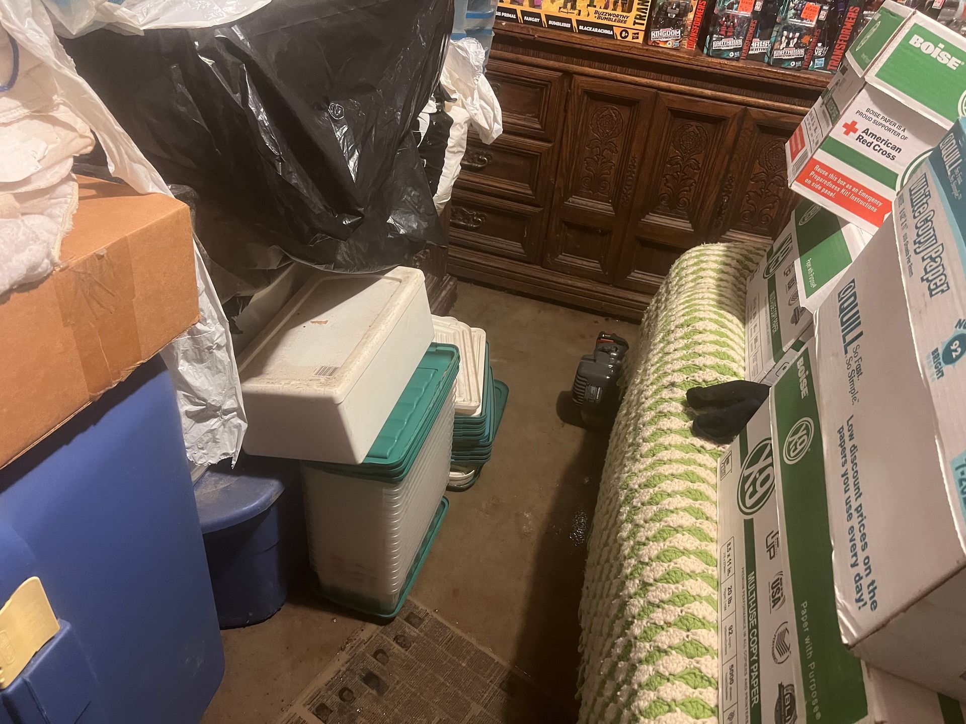 A room filled with lots of boxes and a bed.