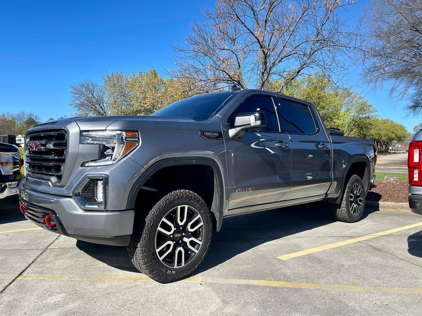 Gray GMC Sierra truck parked outdoors on a sunny day.