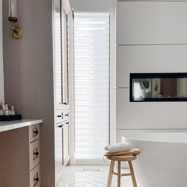 A bathroom with a tub and a stool in it