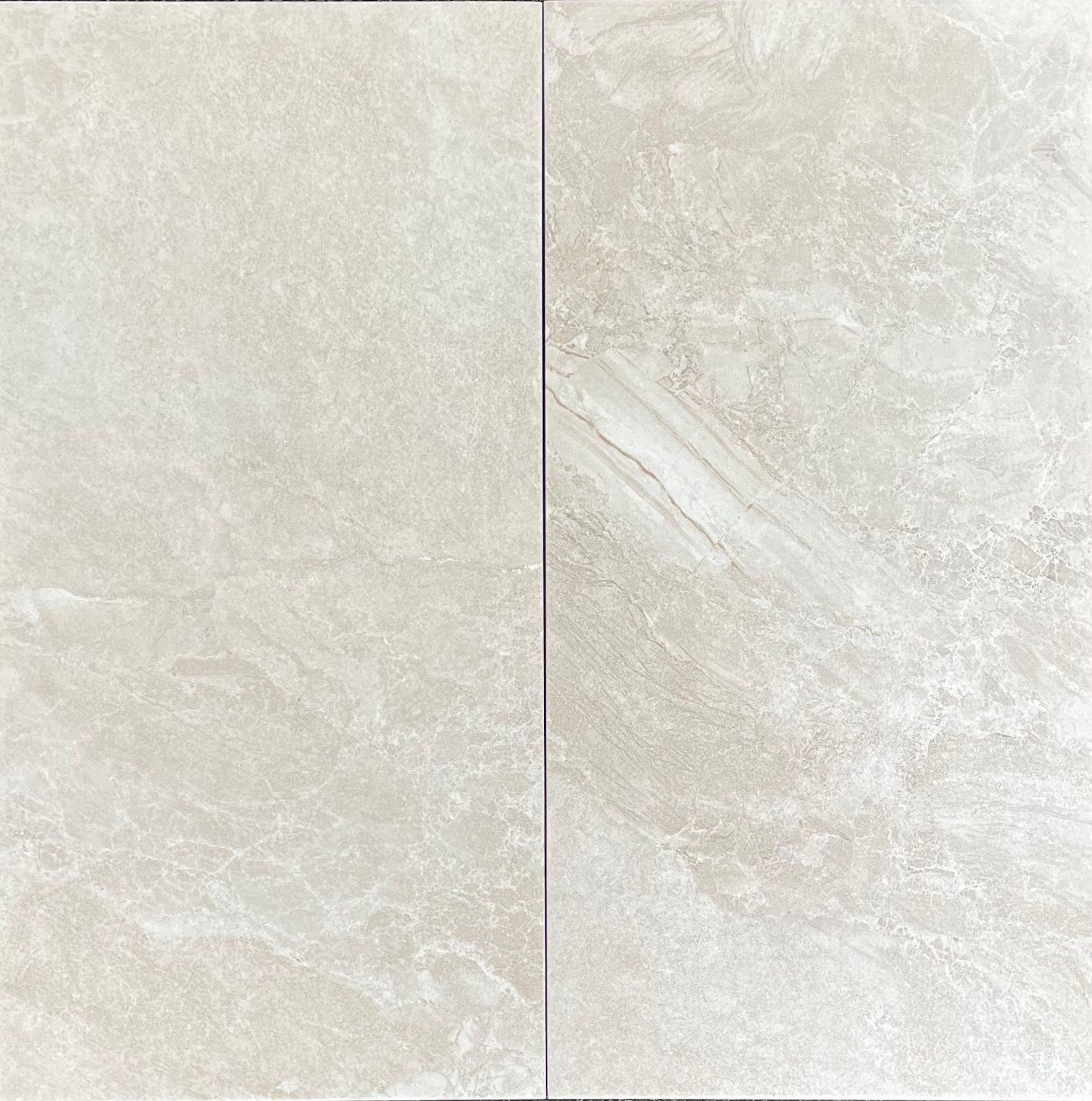 Two light beige-colored tiles with a marble-like texture.