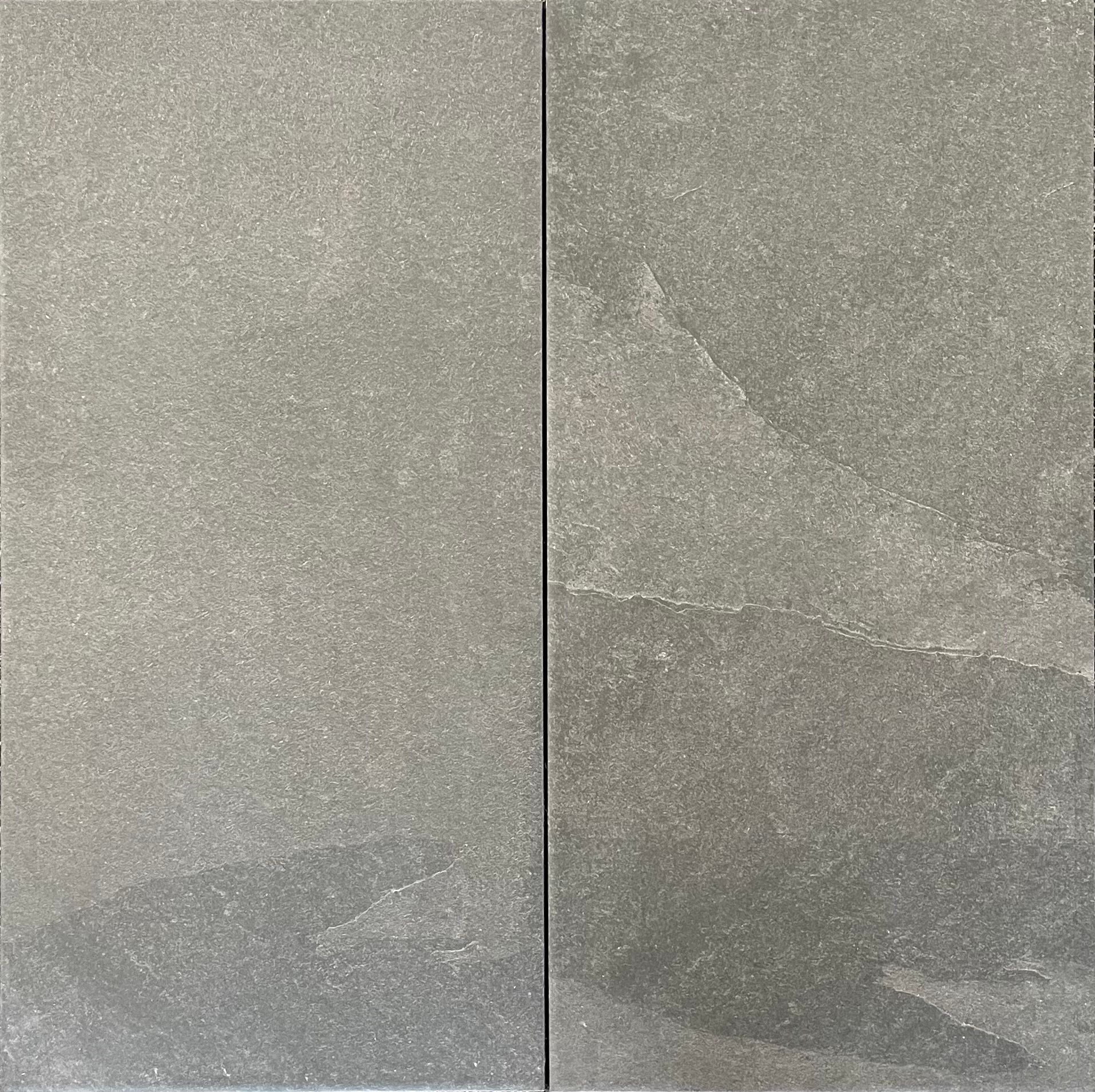 Two gray rectangular tiles side by side, with a subtle textured surface.