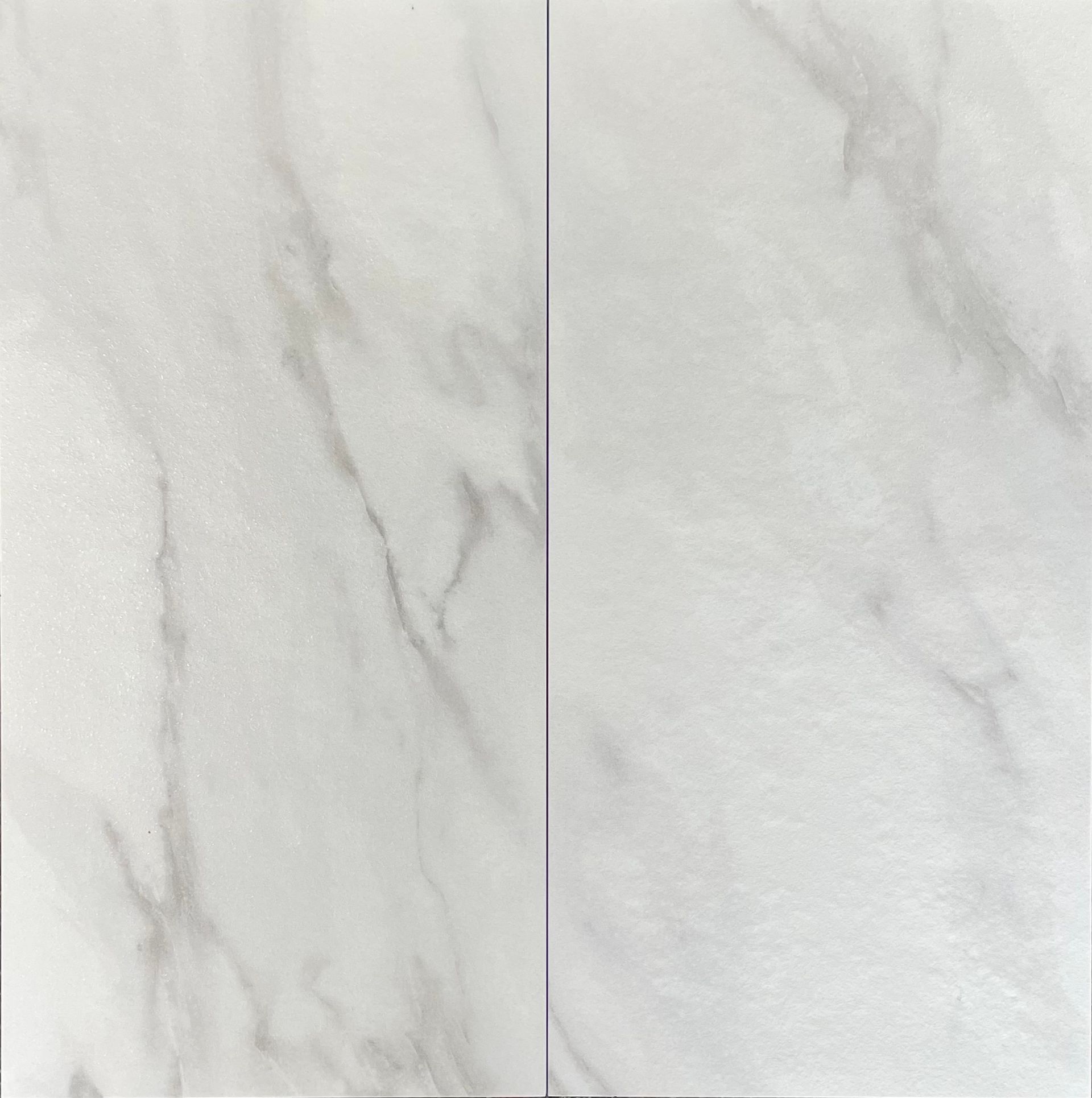 Two white glossy tiles with wave-like texture, separated by a thin vertical line.