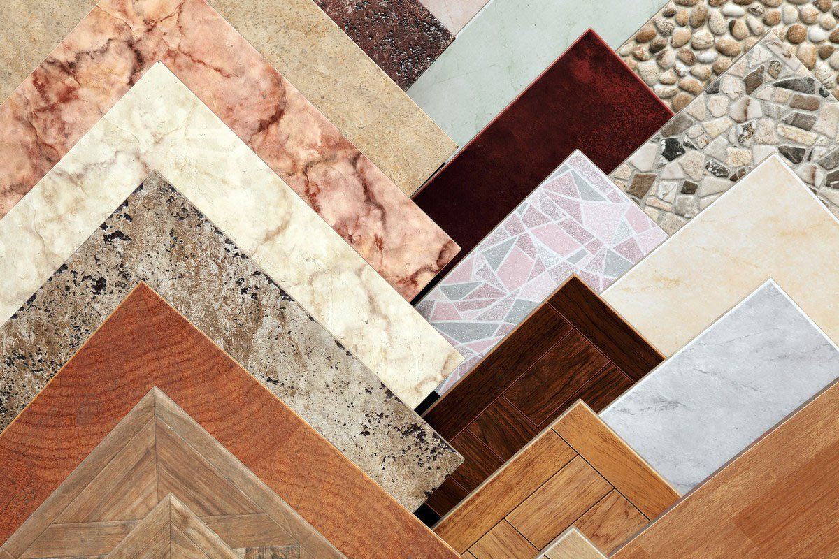 Assorted floor tile samples in various patterns and textures, arranged in a zig-zag pattern.