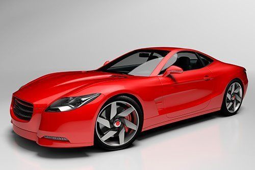 Red sports car with black interior on a white surface.