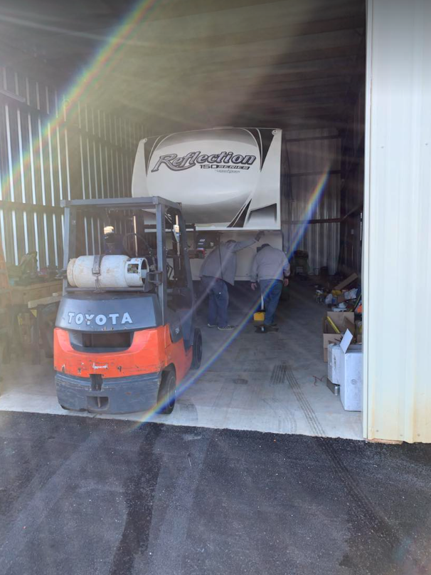 an rv is being lifted by a toyota forklift