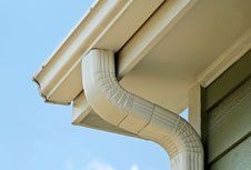 A close-up of a gutter on the side of a house.