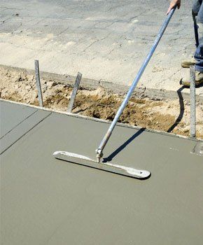 Workman finishes and smooths concrete surface