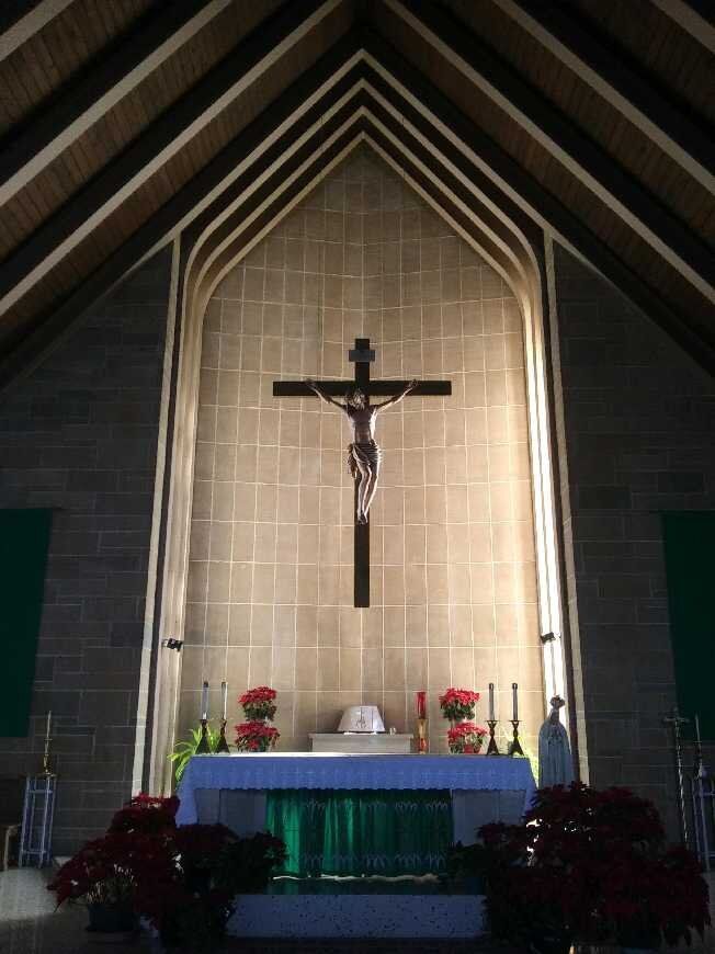 The inside of a church with a cross on the wall