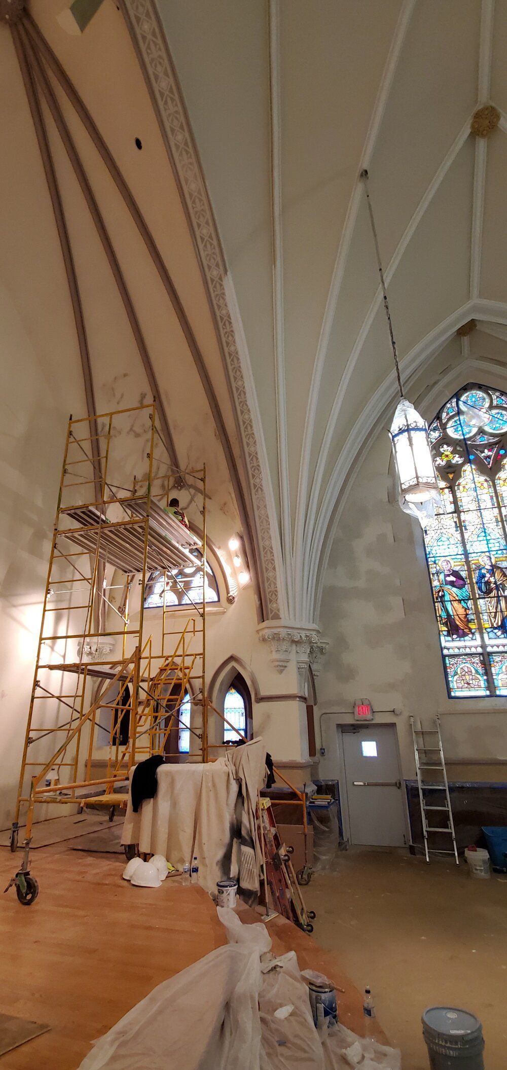 A church with a stained glass window is being restored.