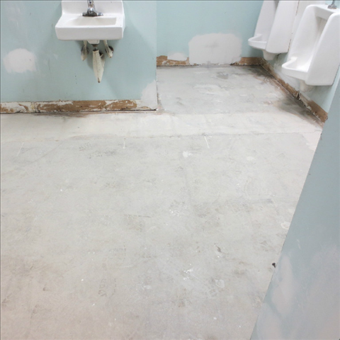 A bathroom with a sink and urinals in it