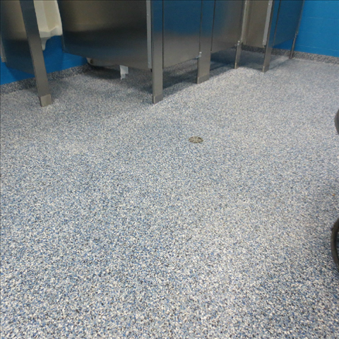 A bathroom with stainless steel sinks and a blue wall