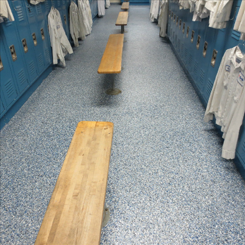 A row of wooden benches in a locker room