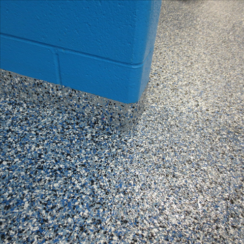 A blue brick wall is behind a blue floor