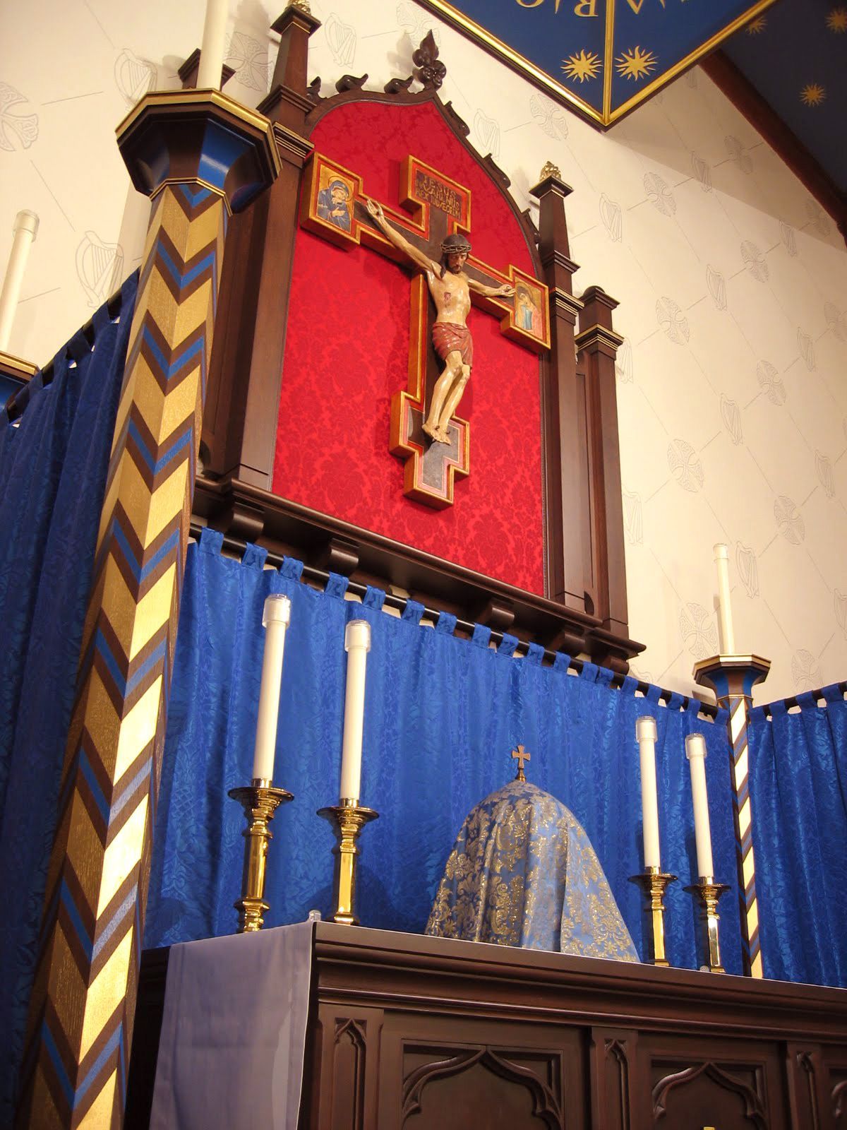 A church altar with a cross and candles on it